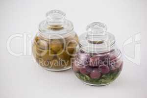 High angle view red and green olives in glass jar
