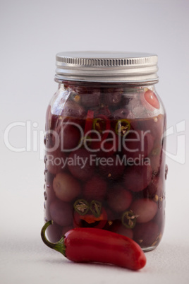 Red olives with jalapeno in container