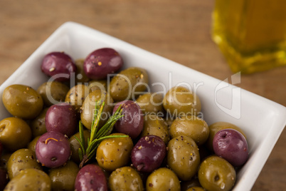 Close up of olives with rosemary served in bowl