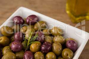 Close up of olives with rosemary served in bowl