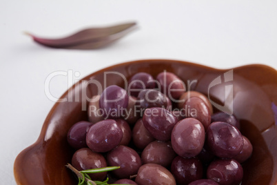 Close up of brown olives in wooden container