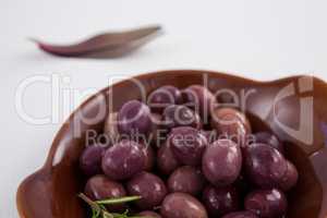 Close up of brown olives in wooden container