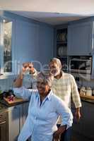 Happy senior couple dancing at home