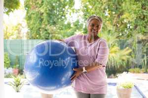 Portrait of woman holding exercise ball