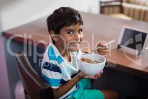 Portrait of boy having breakfast