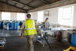 Worker pulling a trolley with crate