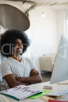 Smiling man sitting at desk in office