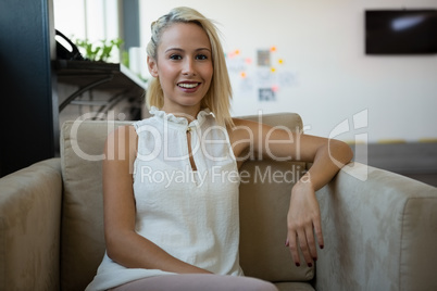Portrait of smiling businesswoman on sofa