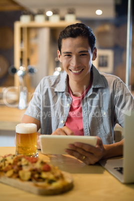 Man using digital tablet in restaurant