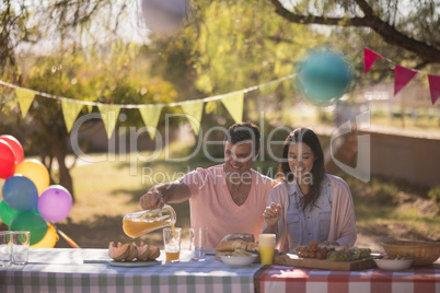 Couple having meal in park