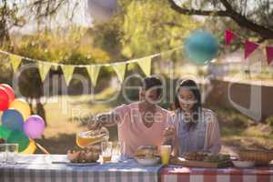 Couple having meal in park