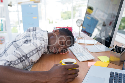 Male executive resting at his desk