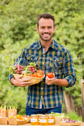 Portrait of young man selling organic vegetables