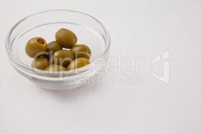High angle view of green olives in bowl