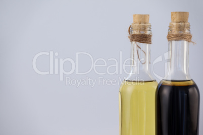 Olive oil in bottles against wall