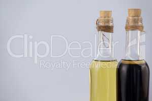 Olive oil in bottles against wall
