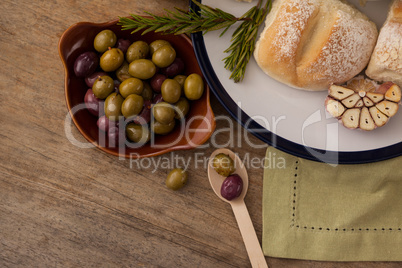 Olives and bread in plate