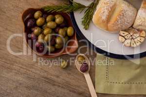 Olives and bread in plate