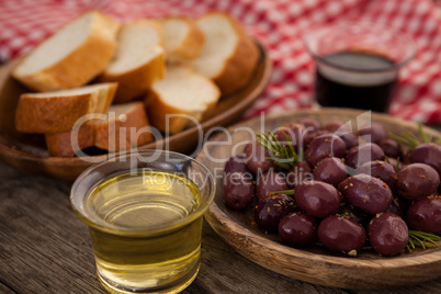 Olives and bread with oil in container