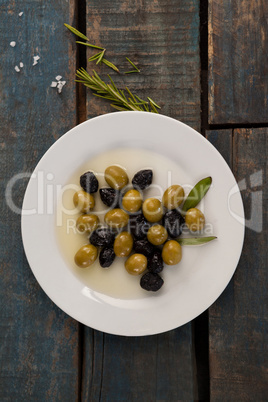 Overhead view of olives in plate with oil