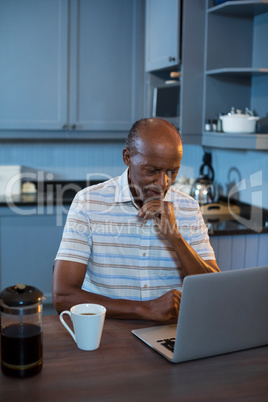 Man using laptop at table