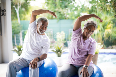 Portrait of senior couple exercising in yard