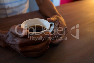 Close up of man holding coffee cup