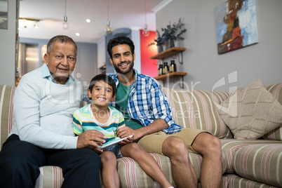 Portrait of smiling family sitting on sofa