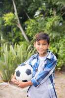 Portrait of smiling boy holding soccer ball