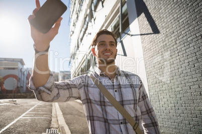 Smiling young man looking away while gesturing