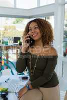 Businesswoman looking away while talking on phone
