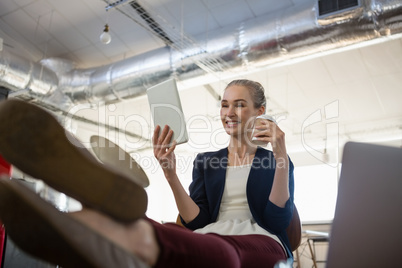 Businesswoman using digital tablet while relaxing Businesswoman using digital tablet while relaxing