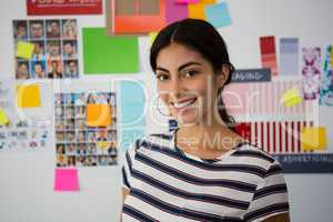 Portrait of beautiful woman against sticky notes in office