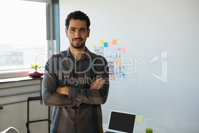 Portrait of young man standing at office