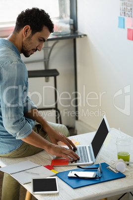 Man using laptop in office