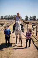 Kids riding a horse in the ranch