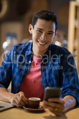 Man using mobile phone in restaurant