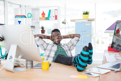 Male executive relaxing at his desk