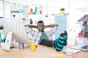 Male executive relaxing at his desk