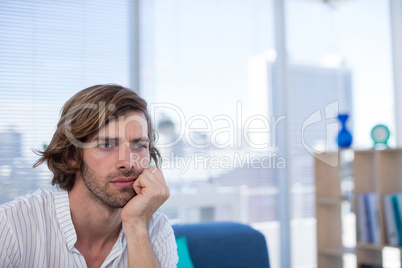 Depressed male executive sitting on sofa