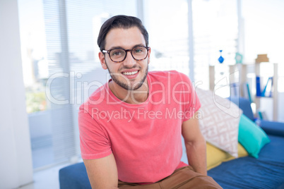 Male executive relaxing on sofa in the office