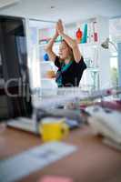 Female executive doing yoga in office