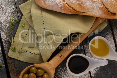 Overhead view of olive oil by bread on table