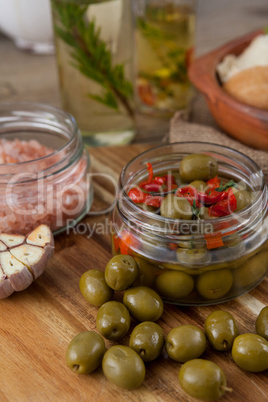 High angle view of olives and spices in container