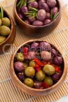High angle view of various olives in wooden containers