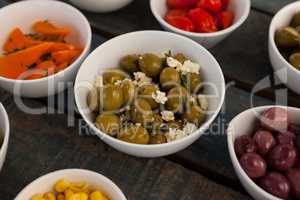 Close up of green olives with cheese by various food