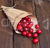 Ripe red cherry in a paper bag