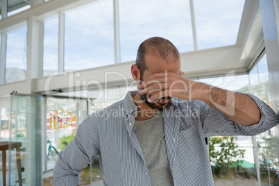 Tensed designer standing in office