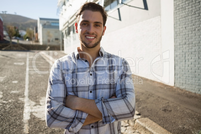 Portrait of happy man with arms crossed