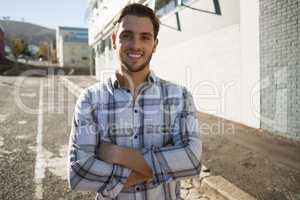 Portrait of happy man with arms crossed